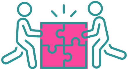 Two people connecting puzzle pieces together